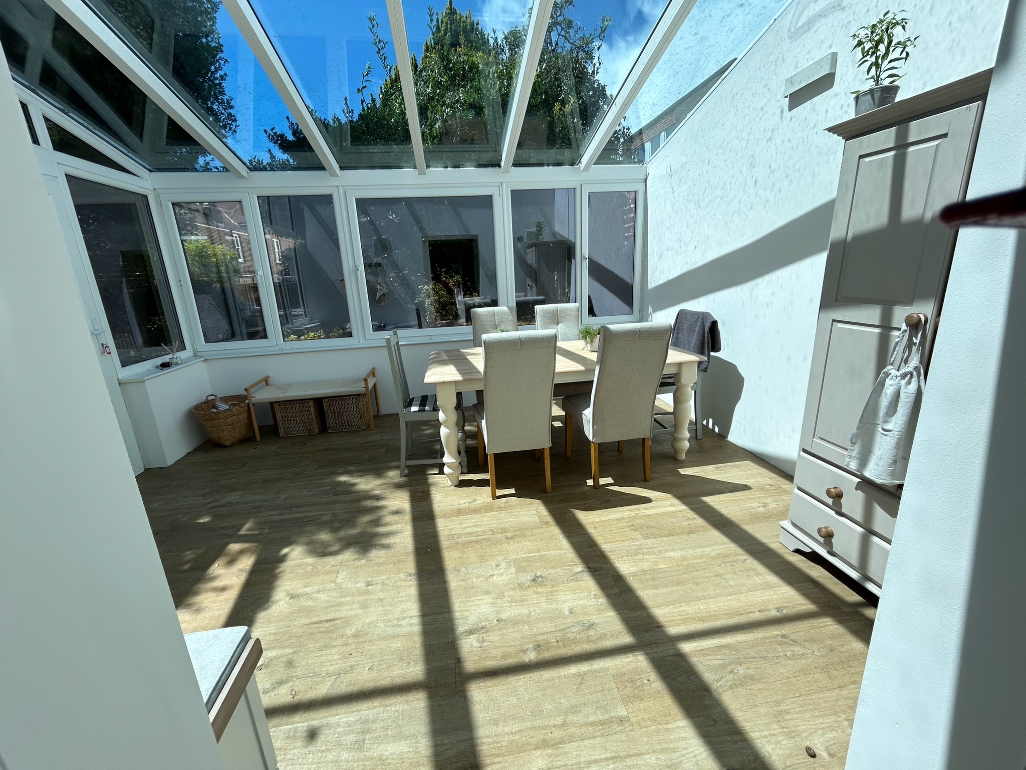 Sunlit conservatory and dining room at The Coach House in Queen’s Park, Brighton.